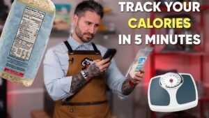 Man tracking calories with phone app, holding food package.