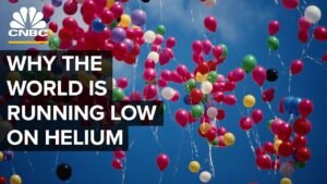 Colorful balloons in sky, helium shortage discussion.