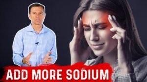 Doctor discussing sodium benefits, woman experiencing headache.