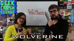 Two hosts reviewing "The Wolverine" with themed props.