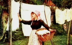 Woman hanging laundry in rustic outdoor setting.